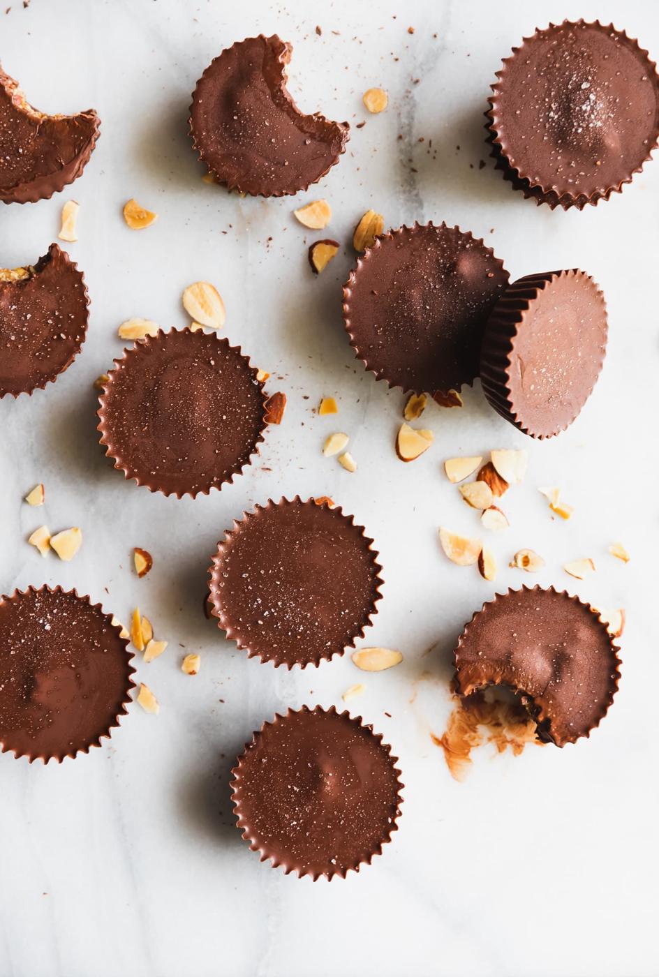 These almond butter cups are made with just 5 ingredients - dark chocolate, coconut oil, almond butter, chopped almonds, and sea salt. Perfect snack!