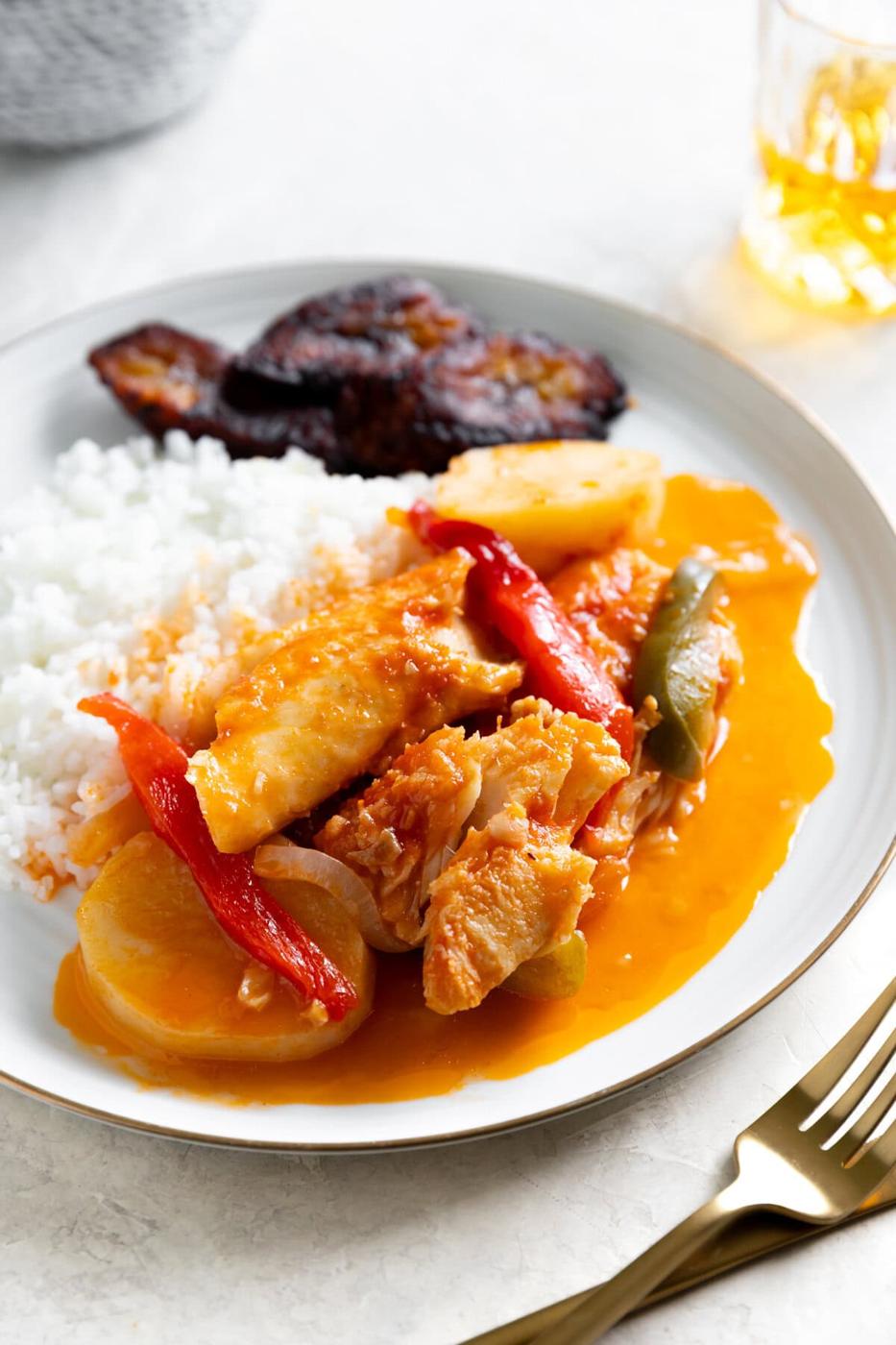 Creamy chicken and vegetable curry with rice and side of barbecue ribs, flavorful and comforting meal.