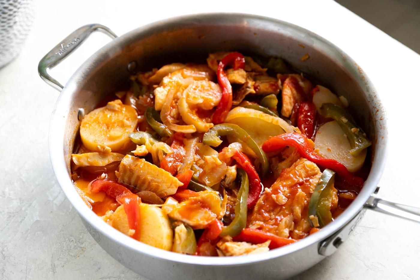 Stewed chicken with colorful bell peppers and potatoes, home-cooked comfort food from A Sassy Spoon®.
