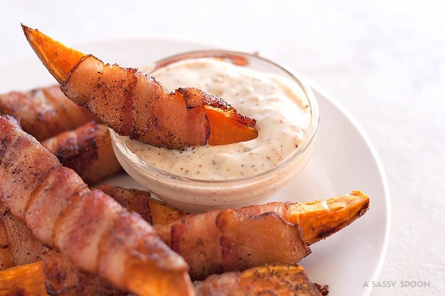 Sweet potatoes cut into fries, seasoned with salt, pepper, and smoked paprika then wrapped in bacon and baked to perfection. Best appetizer everrr!