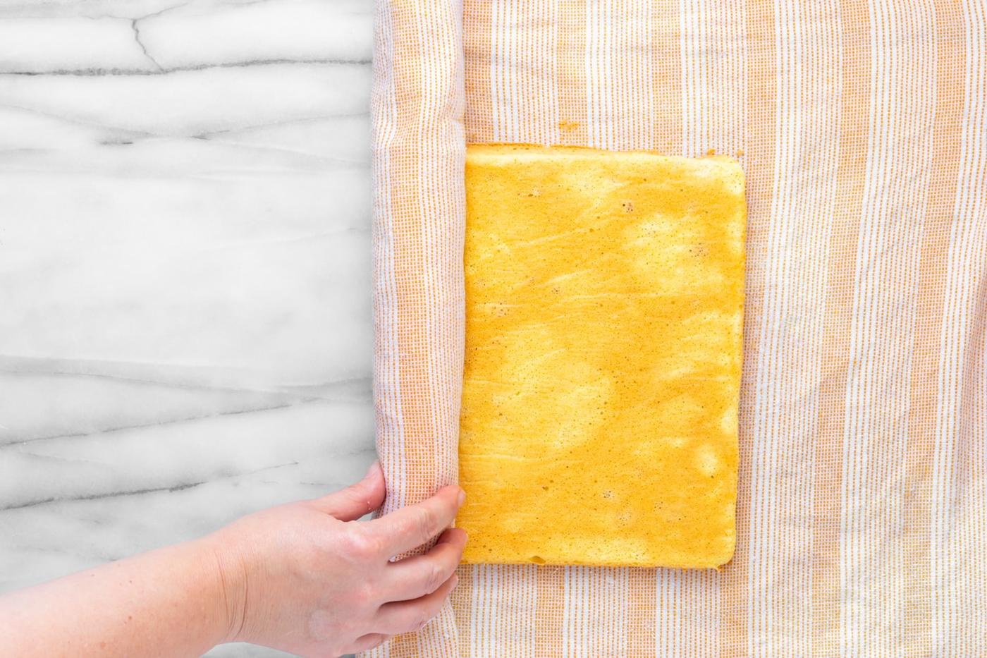 A brazo gitano getting rolled up with a damp towel before filling has been added