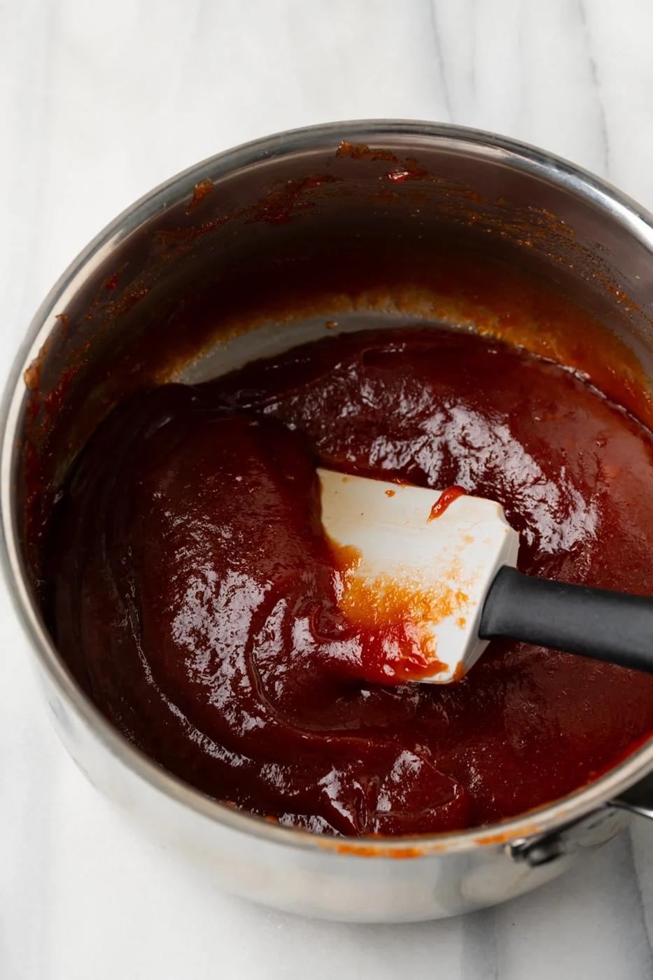 Guava filling for brazo gitano in a saucepan with a spatula in it
