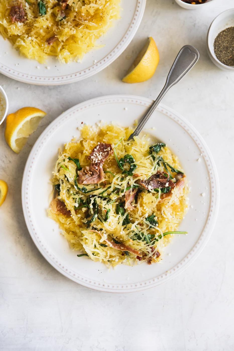 Lemony Cacio e Pepe Spaghetti Squash. A flavorful, low carb meal made with roasted spaghetti squash, lemon, arugula, pancetta, red pepper flakes, grated Parm and fresh pepper. Healthy weeknight dinner!