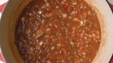simmering the tomato-based sauce with all the veggies and spices