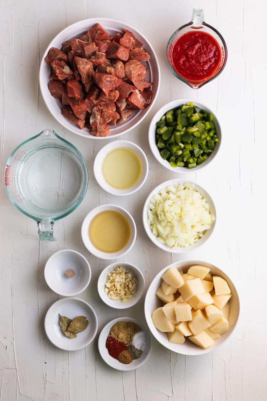 ingredients for carne con papas on a white table