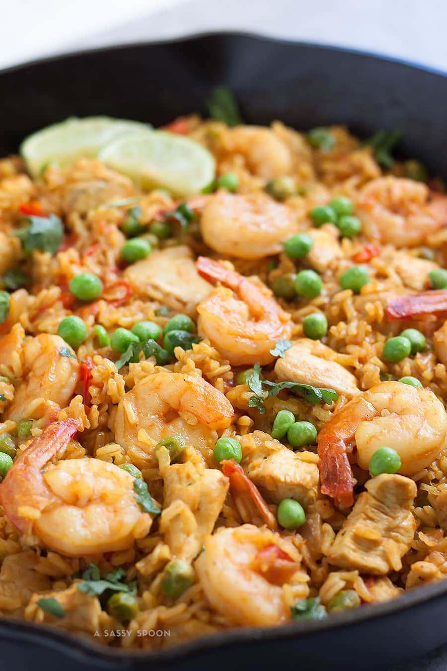 Chicken and shrimp paella in an iron skillet