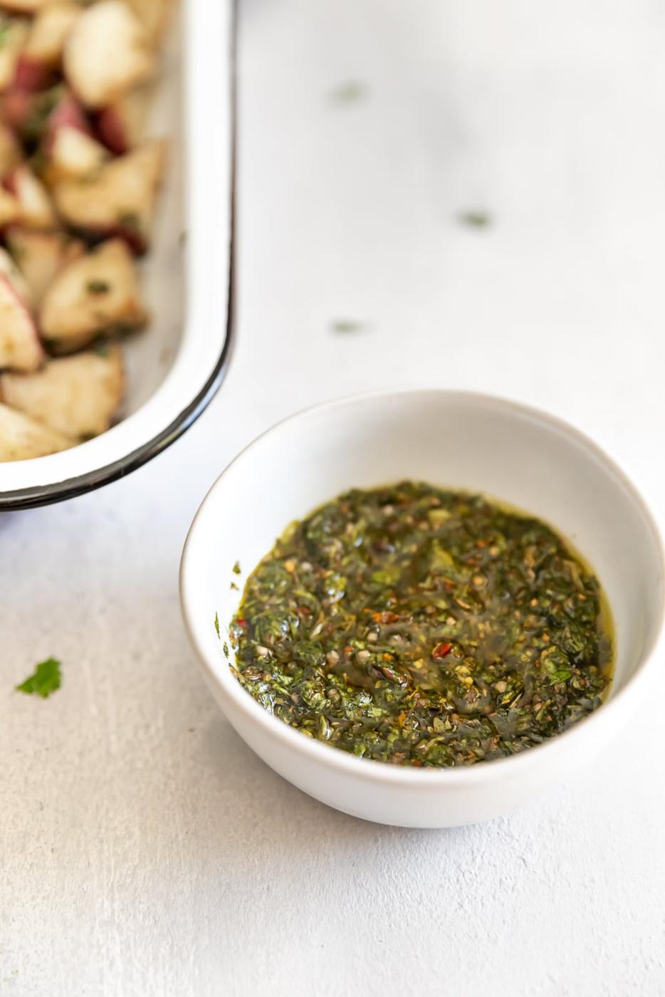 The easiest side dish ever. Roasted potatoes tossed in a delicious, super easy to make cilantro garlic chimichurri sauce!