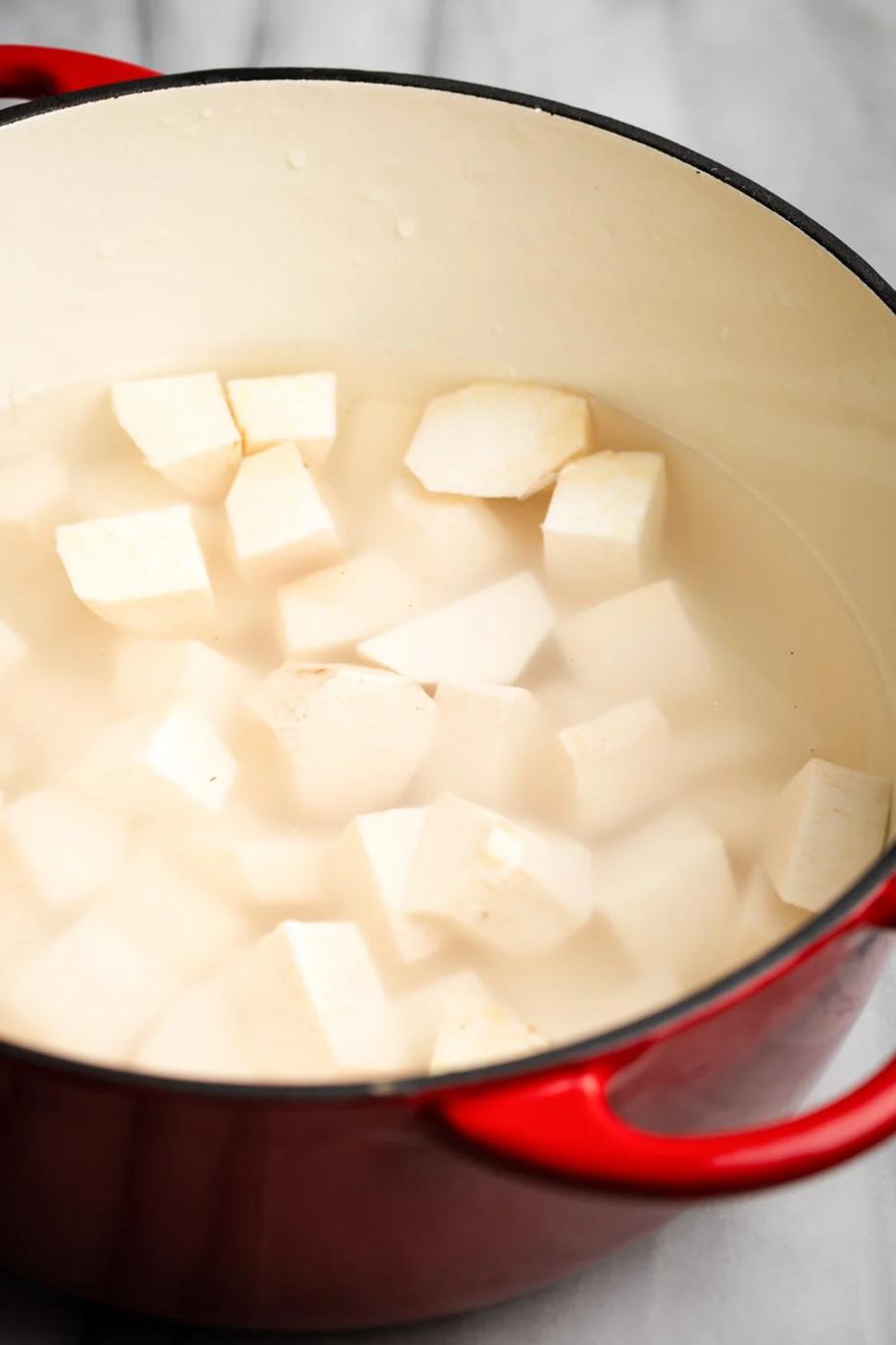 boiling the root vegetables in a Dutch oven until fork-tender