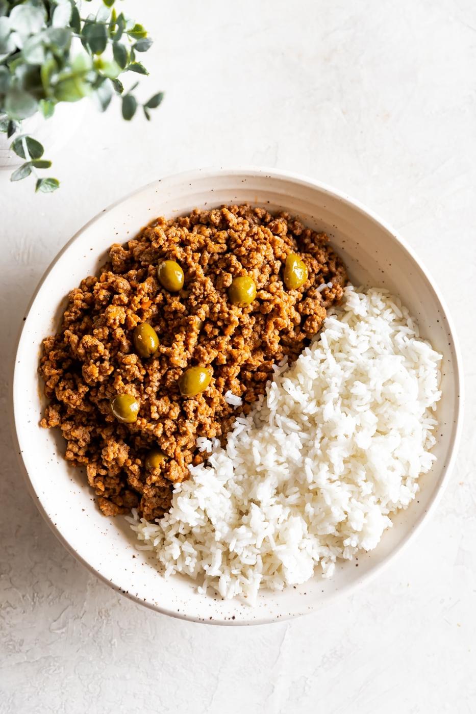 A large bowl of Cuban picadillo and white rice