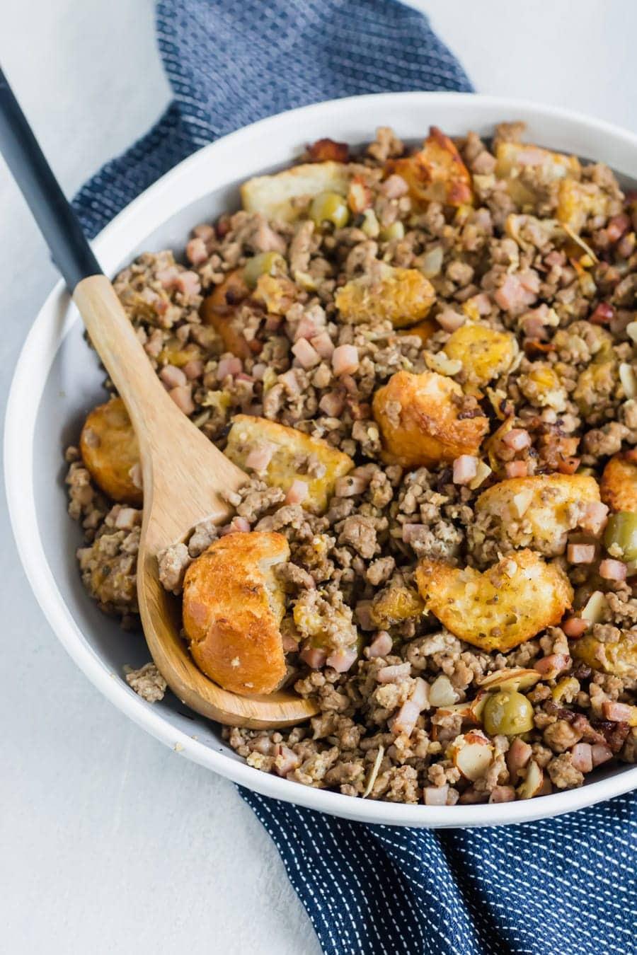 Cubes of toasty French bread mixed with ground beef, ground pork, diced ham, herbs, spices, sliced almonds, chopped olives, and sweet plantains! The BEST stuffing you'll ever try!