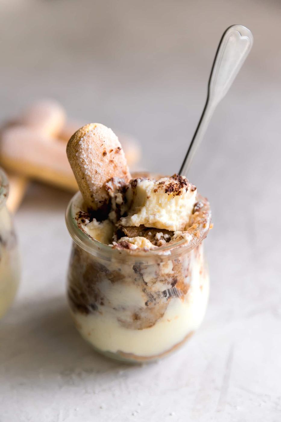 Tiramisu cup with mascarpone mousse, espresso soaked ladyfingers and cocoa powder