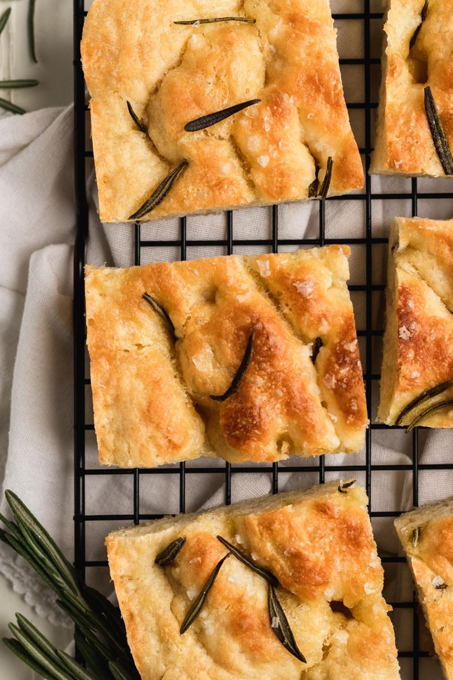 focaccia bread cut in squares with herbs and sea salt