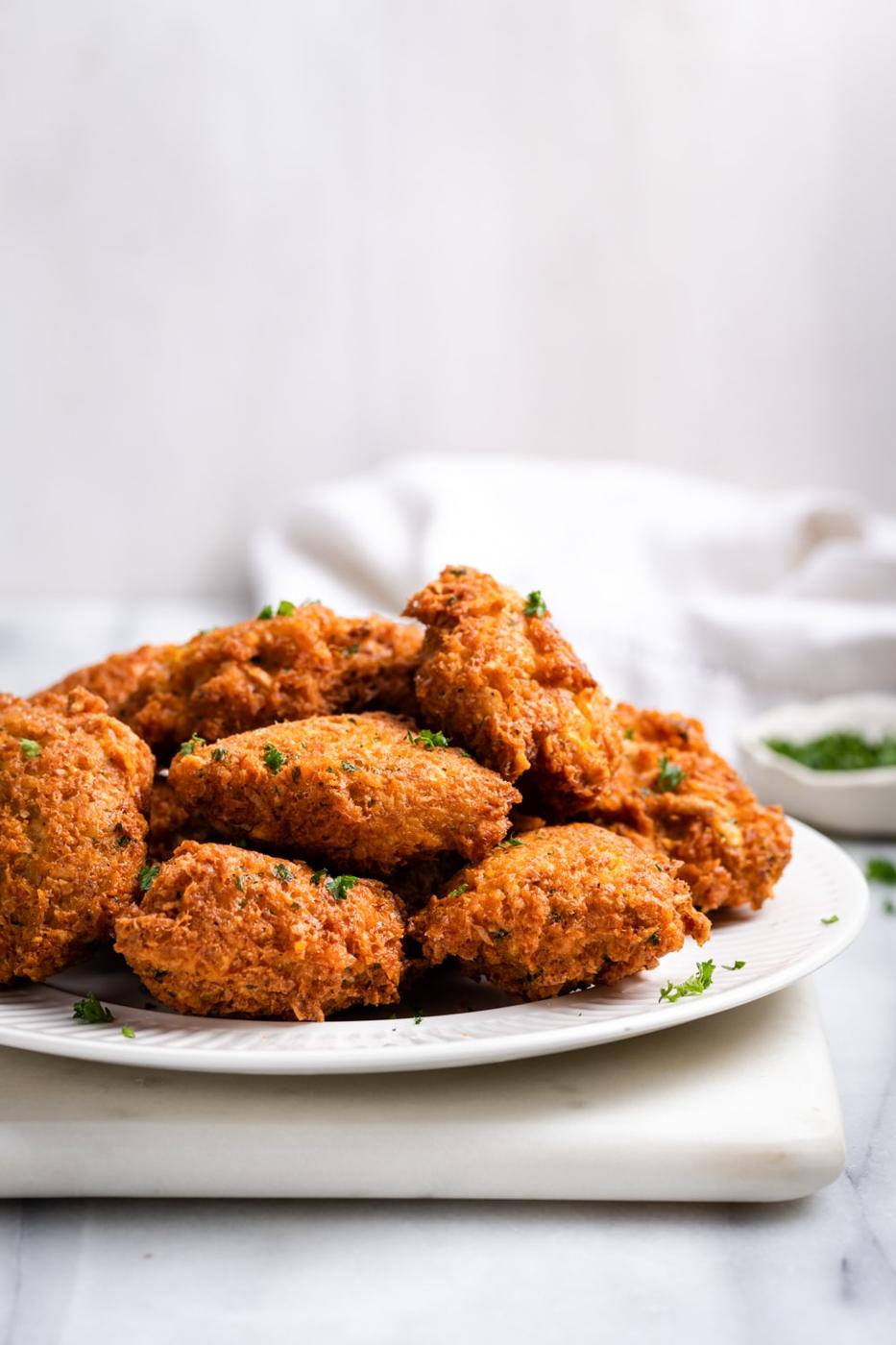 crispy fried malanga fritters on a white plate