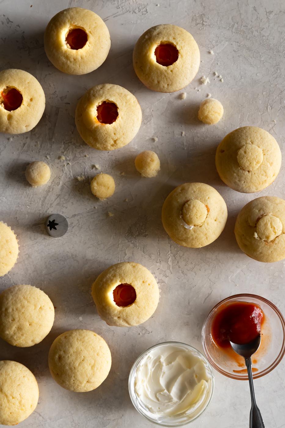 Soft sugar cookies with dollops of jam and creamy frosting, perfect for dessert lovers.