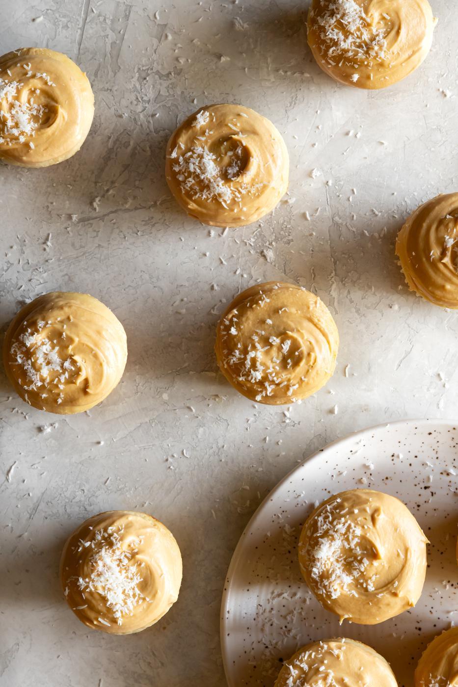 Buttery lemon coconut macarons with shredded coconut topping, perfect for dessert lovers.
