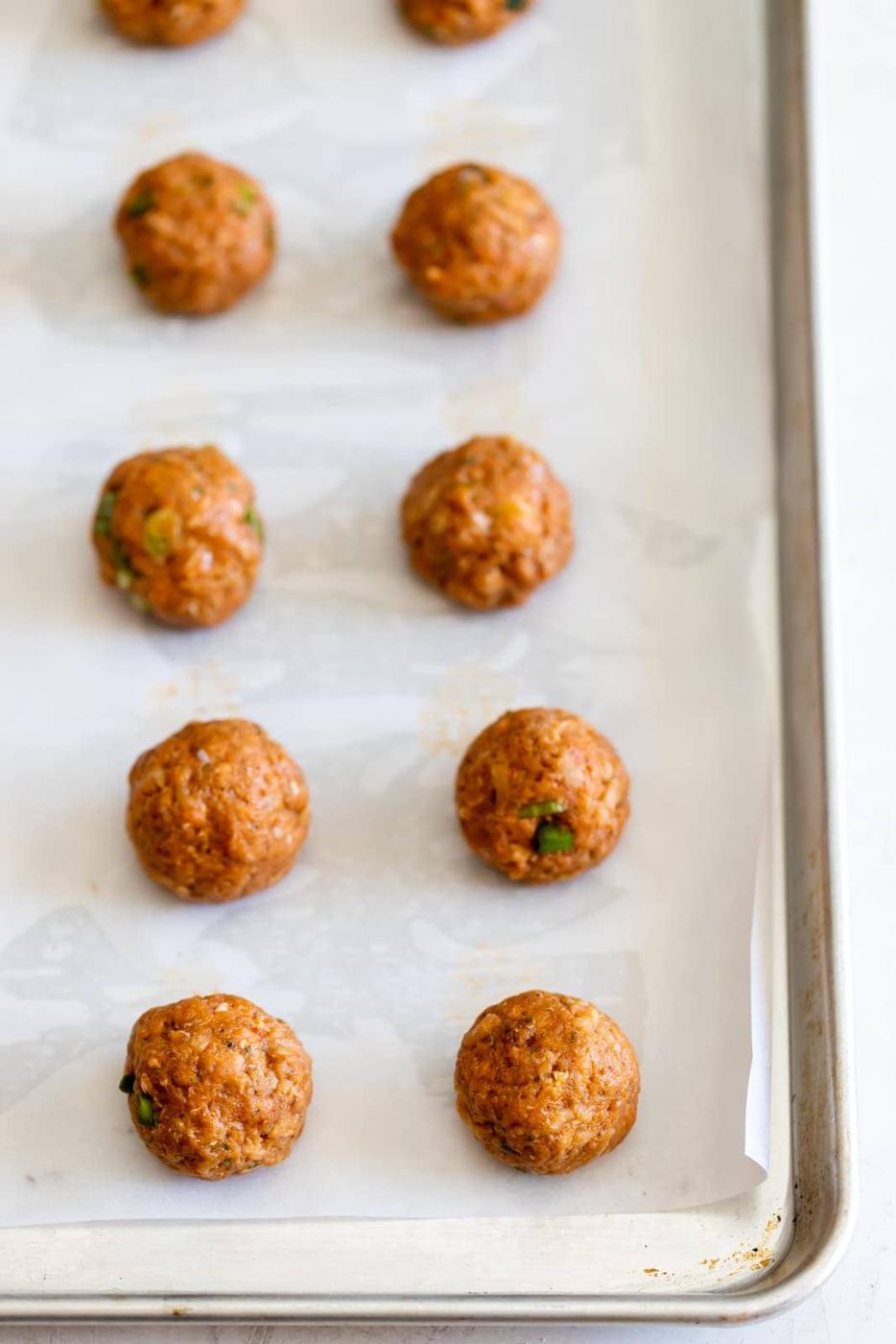 Turkey meatballs laid out on sheet pan