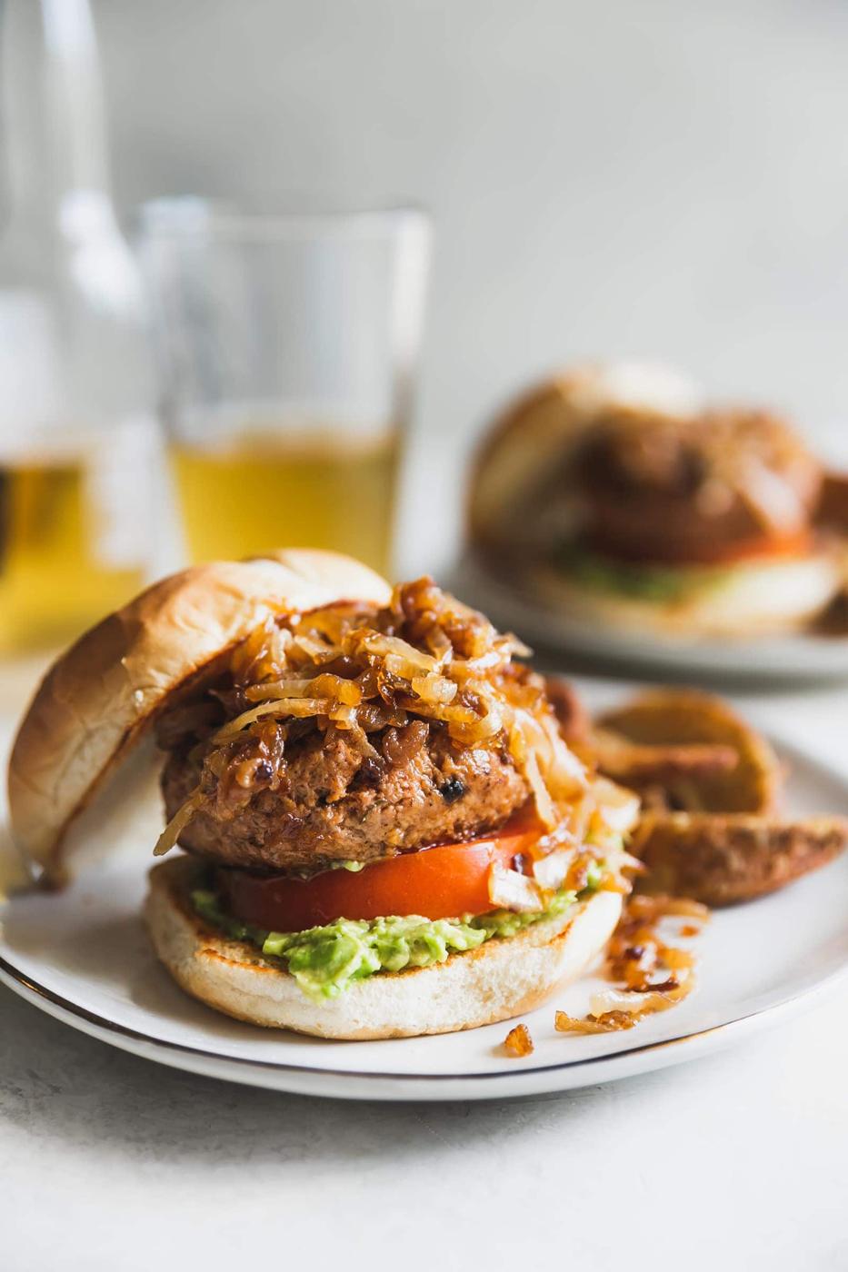 Tender, flavorful juicy turkey burgers made with the best seasoning then topped with mashed avocado, tomato and caramelized onions.