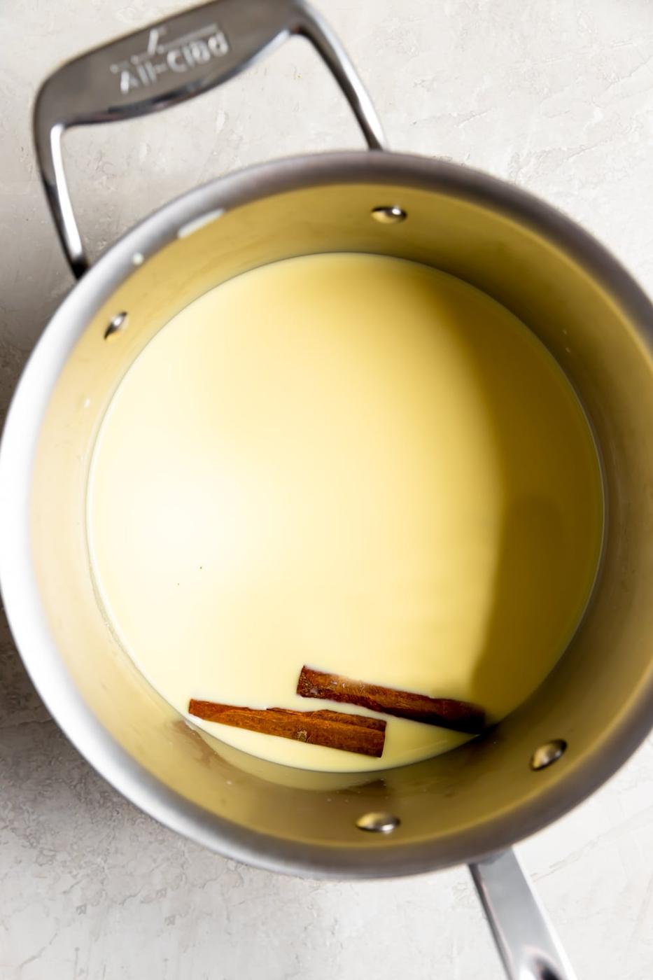 fresh corn kernels blended with milk in a saucepan with cinnamon sticks before cooking