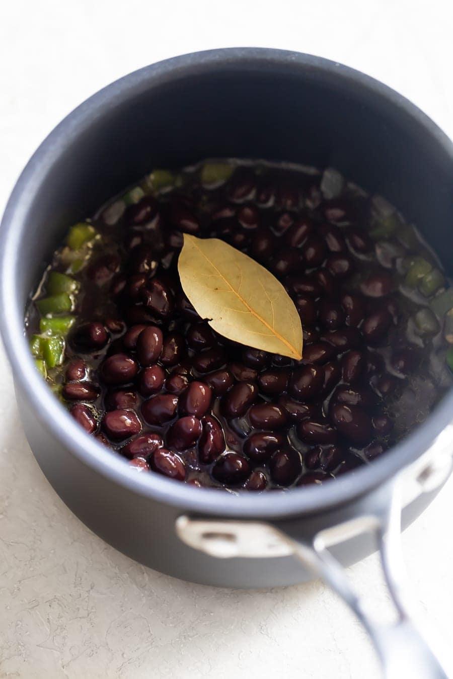 cooked black beans in a saucepan