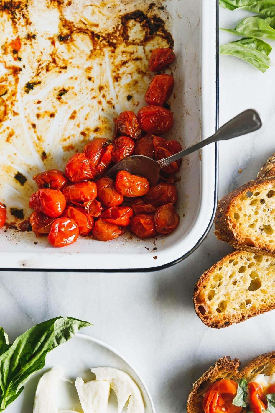 Caprese salad on toast! Cherry tomatoes are roasted until bursting and lightly browned then served with fresh mozzarella on thick, olive-oil-toasted bread.
