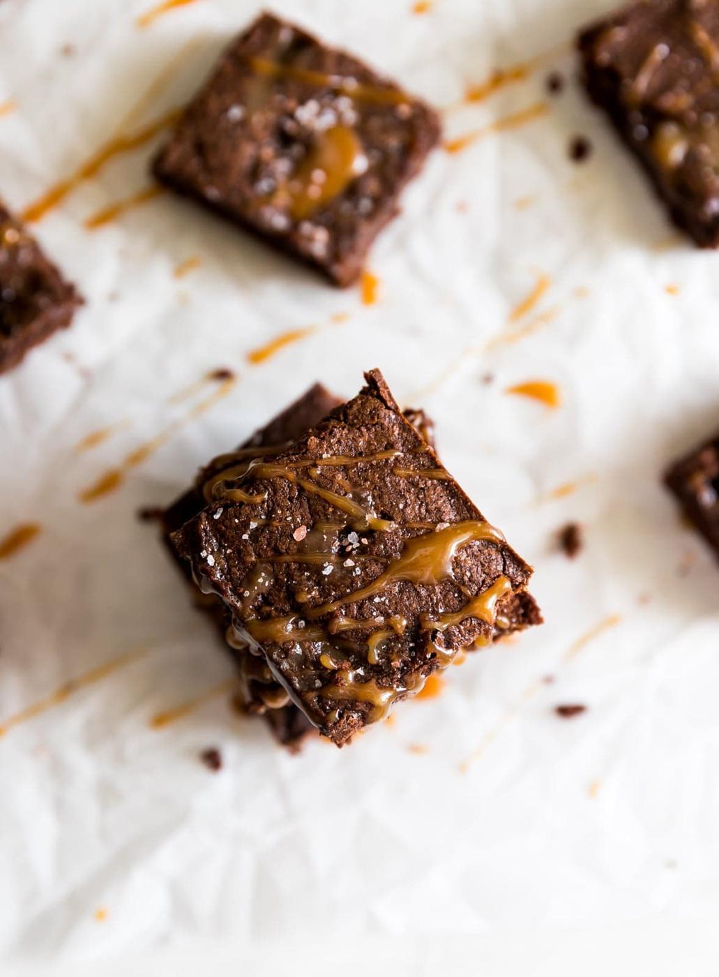 Super thick, fudgy, rich and delicious dark chocolate brownies swirled with homemade salted caramel sauce and a pinch of sea salt!