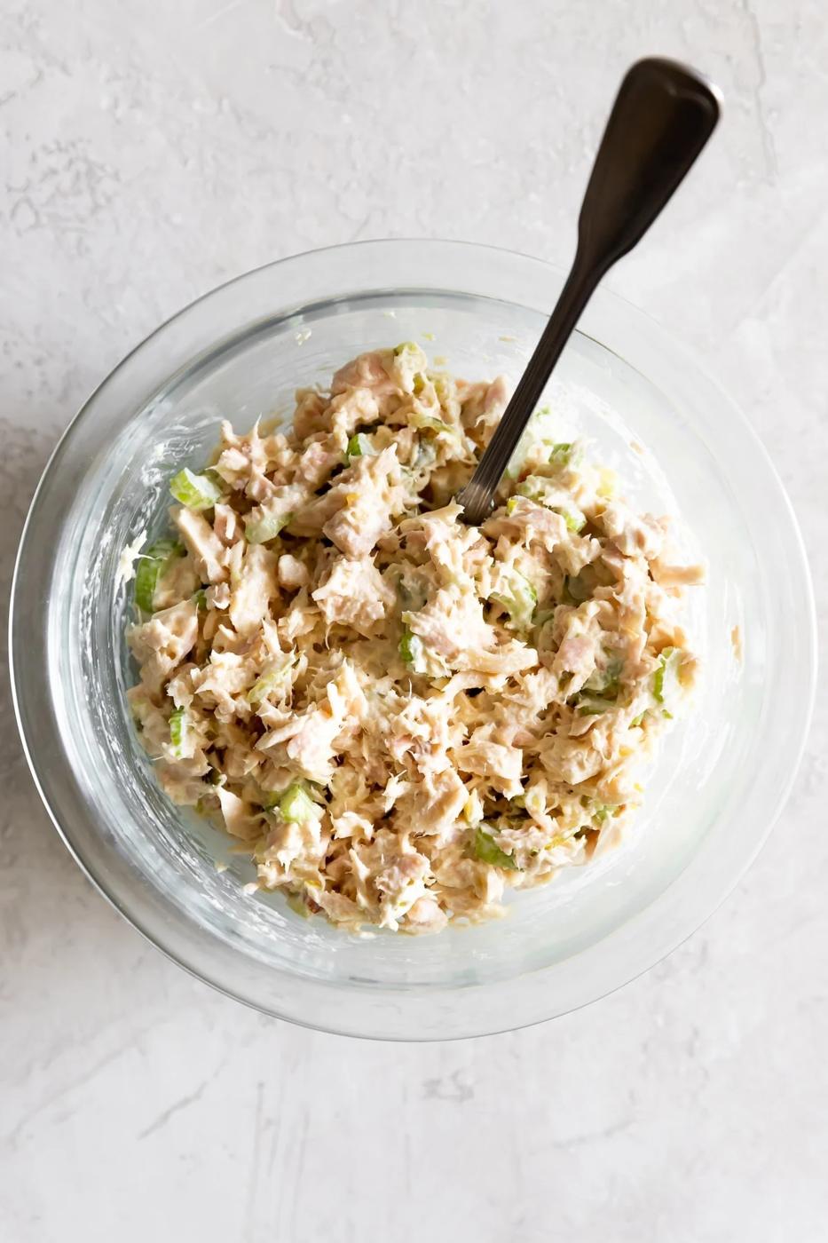 tuna salad mixed with all the ingredients in a clear bowl