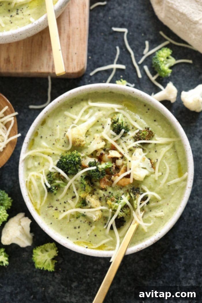 Broccoli cheese soup in a bowl, garnished with fresh herbs