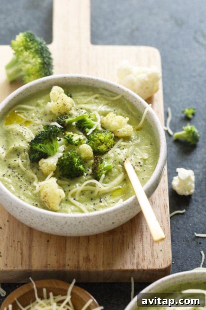 A bowl of creamy broccoli cauliflower cheese soup ready to be served.