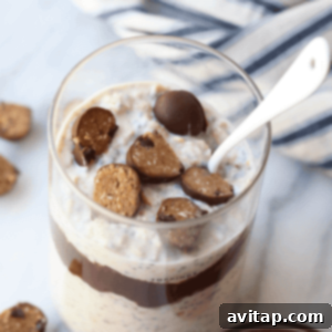 A charming close-up of overnight oatmeal with chocolate chips and a spoon, perfectly prepared and ready to be enjoyed.