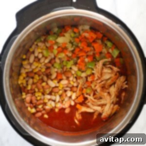 The buffalo chicken chili in the Instant Pot, with all ingredients combined and simmering.