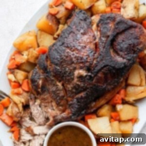 Close-up of a beautifully cooked pork shoulder roast, showing its crispy, caramelized exterior and juicy texture.