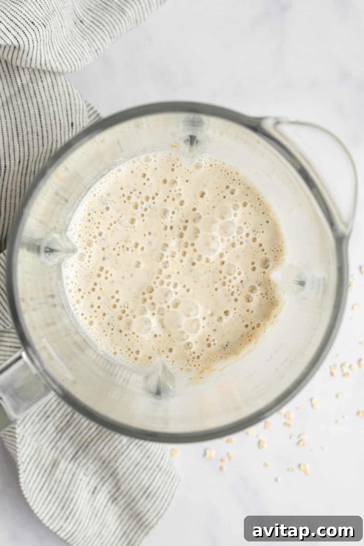 Close-up of the smooth, creamy texture of Coconut Latte Overnight Oats in a glass jar, highlighting its inviting consistency.