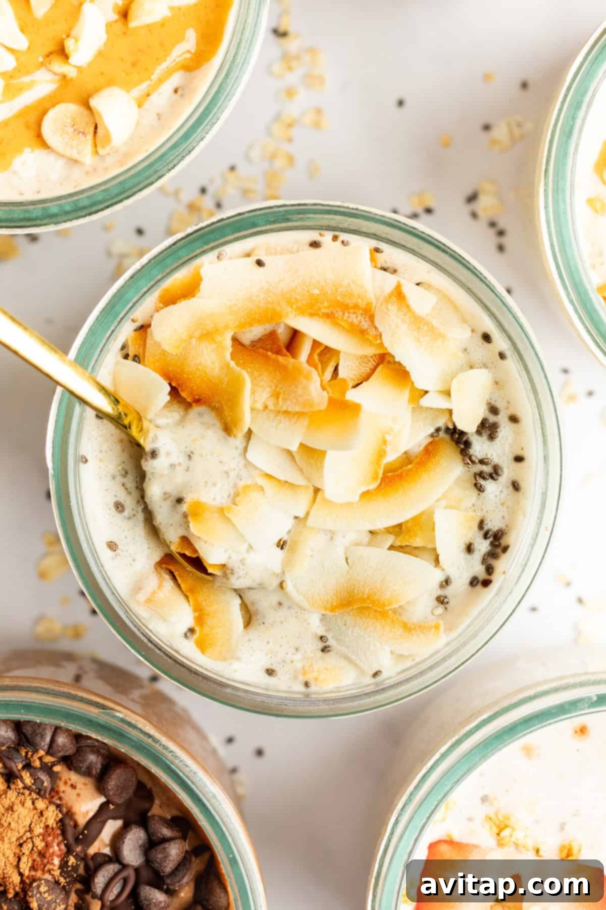Multiple jars of Coconut Latte Overnight Oats neatly stored in a refrigerator, showcasing ideal meal prep.