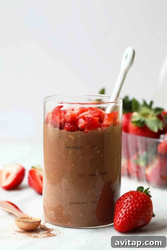 Delicious chocolate covered strawberry overnight oats in a jar, ready to be enjoyed for breakfast.
