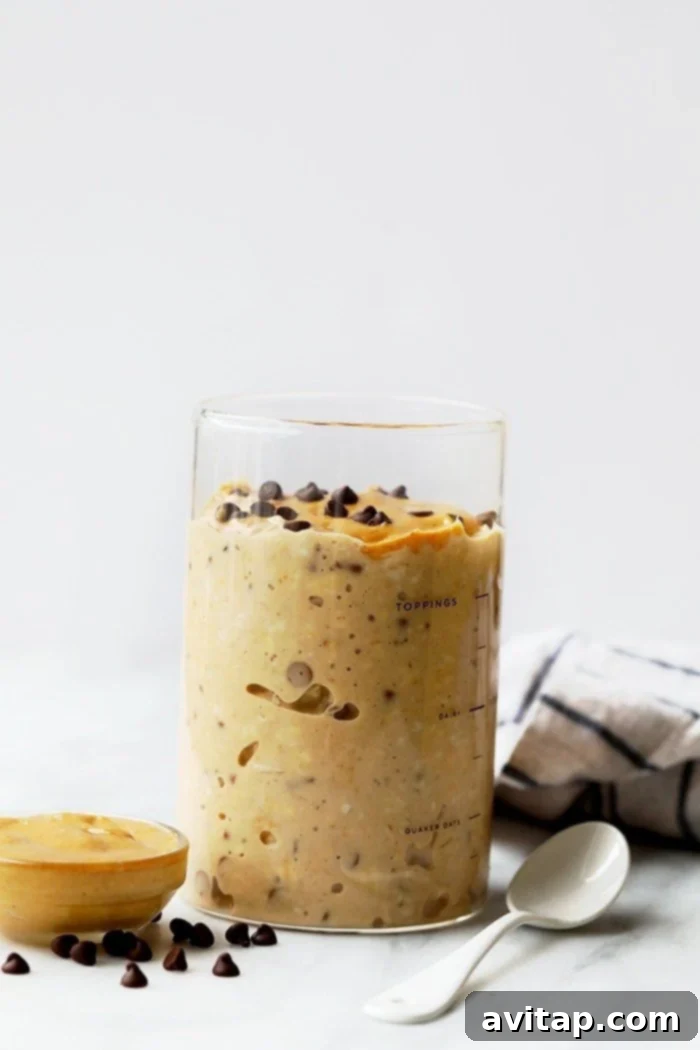 Peanut Butter Chocolate Chip Cookie Dough Overnight Oats in a jar, showcasing a creamy texture and chocolate chips.