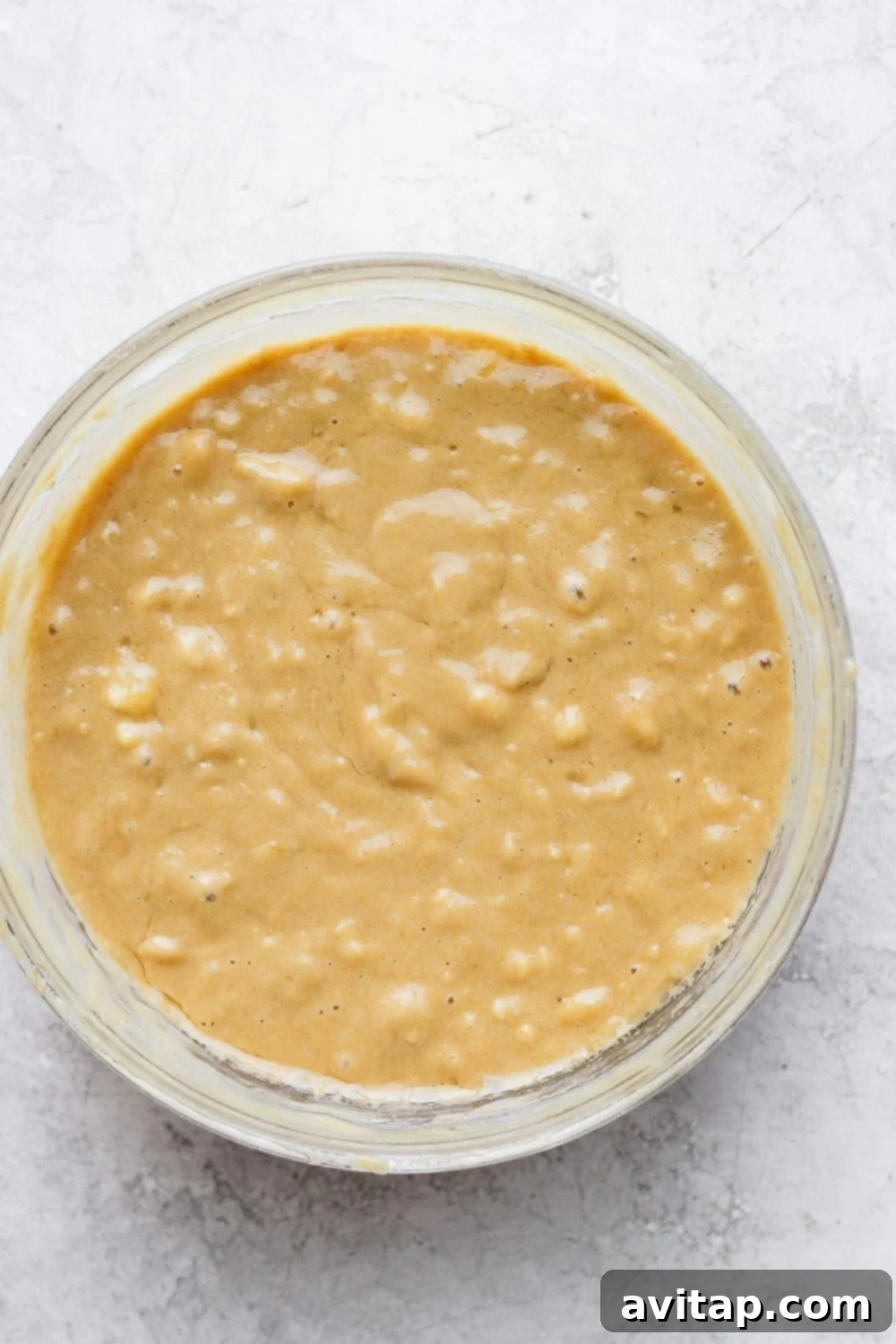 Perfectly Mixed Healthy Banana Bread Batter: Simple Ingredients, Amazing Results Thick, golden-brown banana bread batter in a mixing bowl, ready to be poured into the loaf pan.