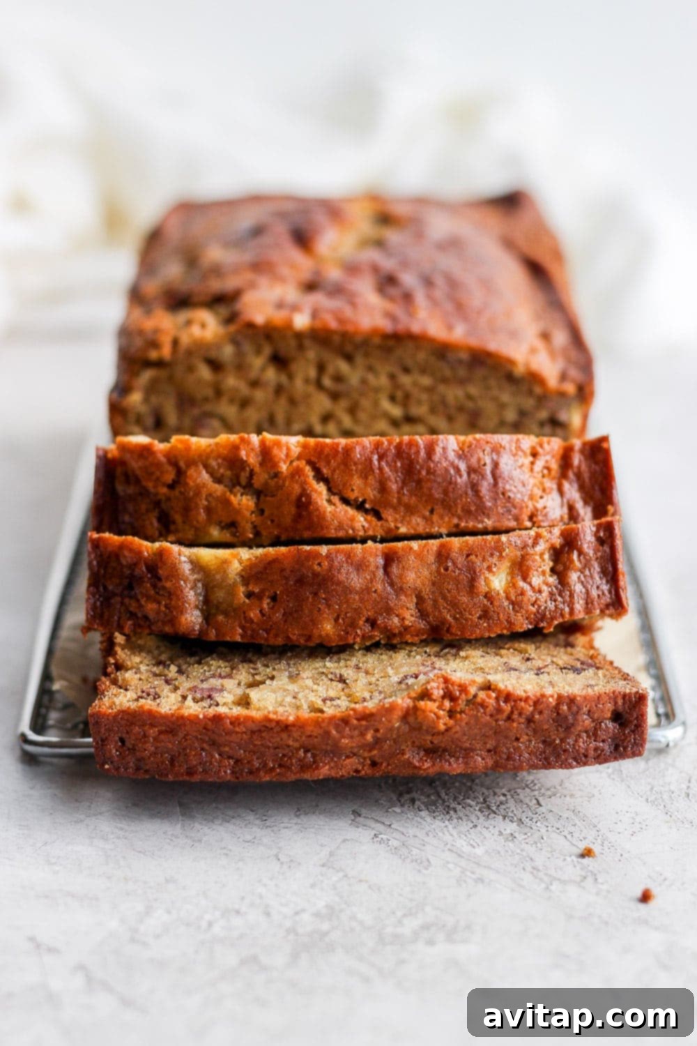 Freshly Sliced Healthy Banana Bread Cooling on Rack Several slices of healthy banana bread cooling on a wire rack, showing off their perfectly baked texture.