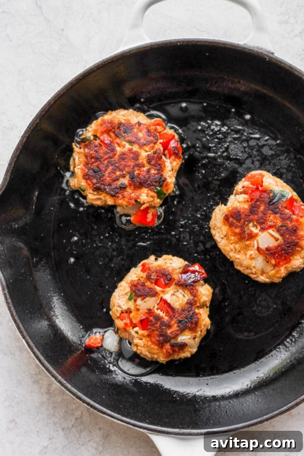 Pan-Frying Salmon Patties to Crisp Perfection Salmon patties pan-frying in a hot skillet, showing a golden crust
