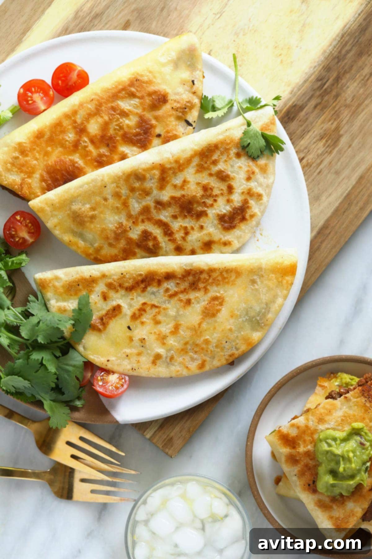 Served Chicken Quesadillas with Guacamole and Cilantro Plate of perfectly cooked chicken quesadilla wedges, garnished with cilantro and served with a side of guacamole.