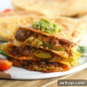 Sliced chicken quesadillas on a plate, ready to be eaten.
