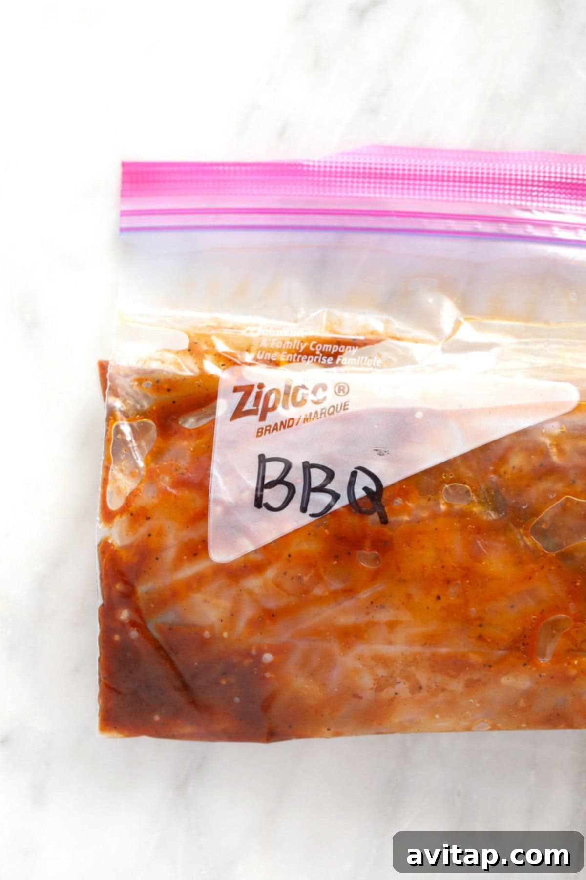 BBQ chicken marinating in a ziploc bag, ready for the freezer or fridge.