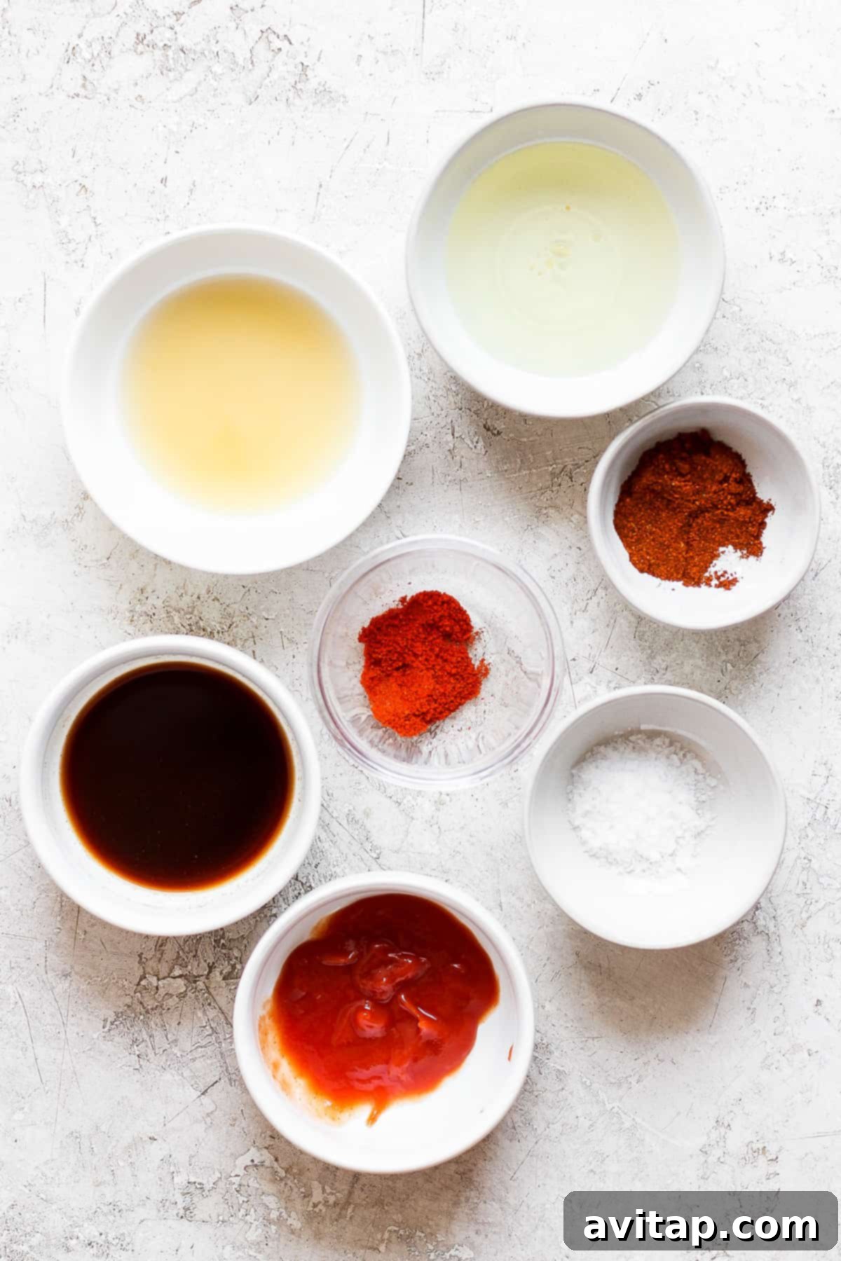 A selection of ingredients for the BBQ chicken marinade laid out on a kitchen counter.