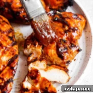 BBQ chicken breasts marinating in a flavorful sauce.