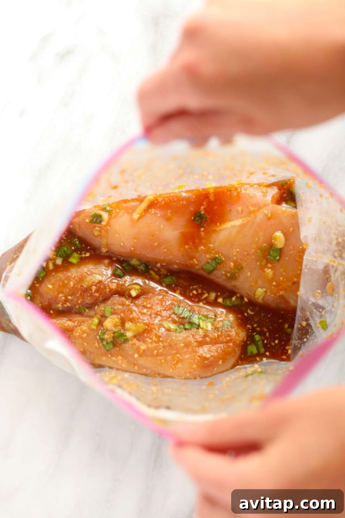Chicken marinating in a plastic bag, ready for freezing or cooking