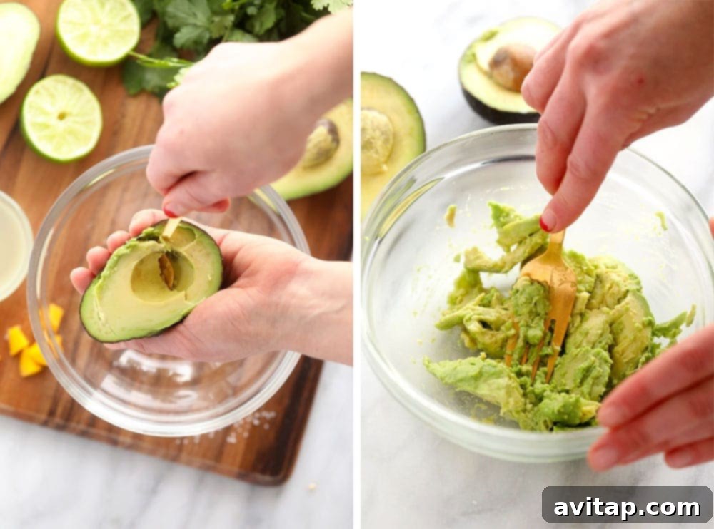 Mashing Avocados for Creamy Guacamole Close-up shot of a hand mashing ripe avocado in a bowl with a fork, demonstrating the preparation process for guacamole.