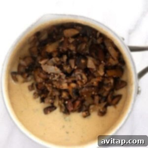 A bowl filled with mushrooms and sauce.