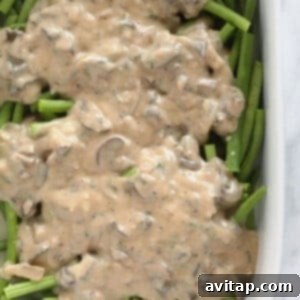 Mushrooms and green beans in a casserole dish.