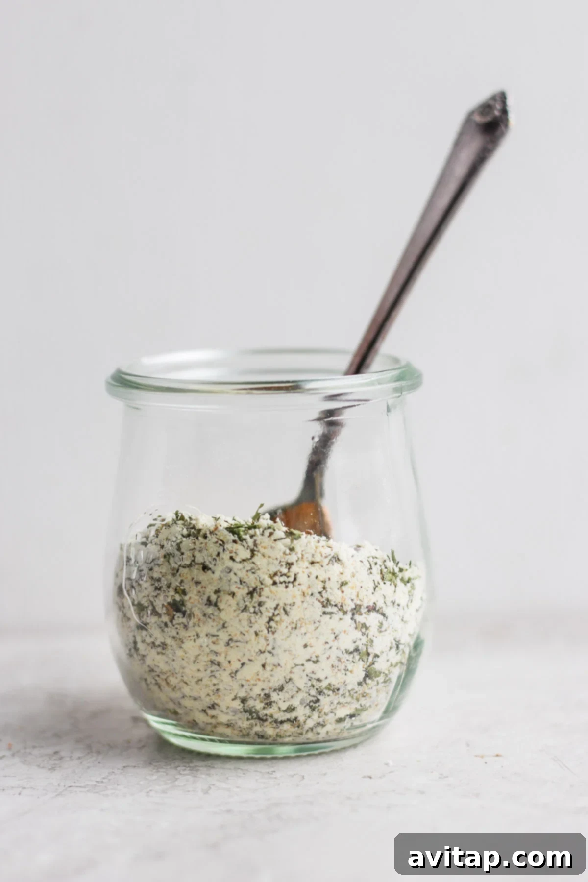A pristine, sealed glass jar filled with vibrant homemade ranch seasoning mix, elegantly labeled and showcasing its readiness for long-term pantry storage.
