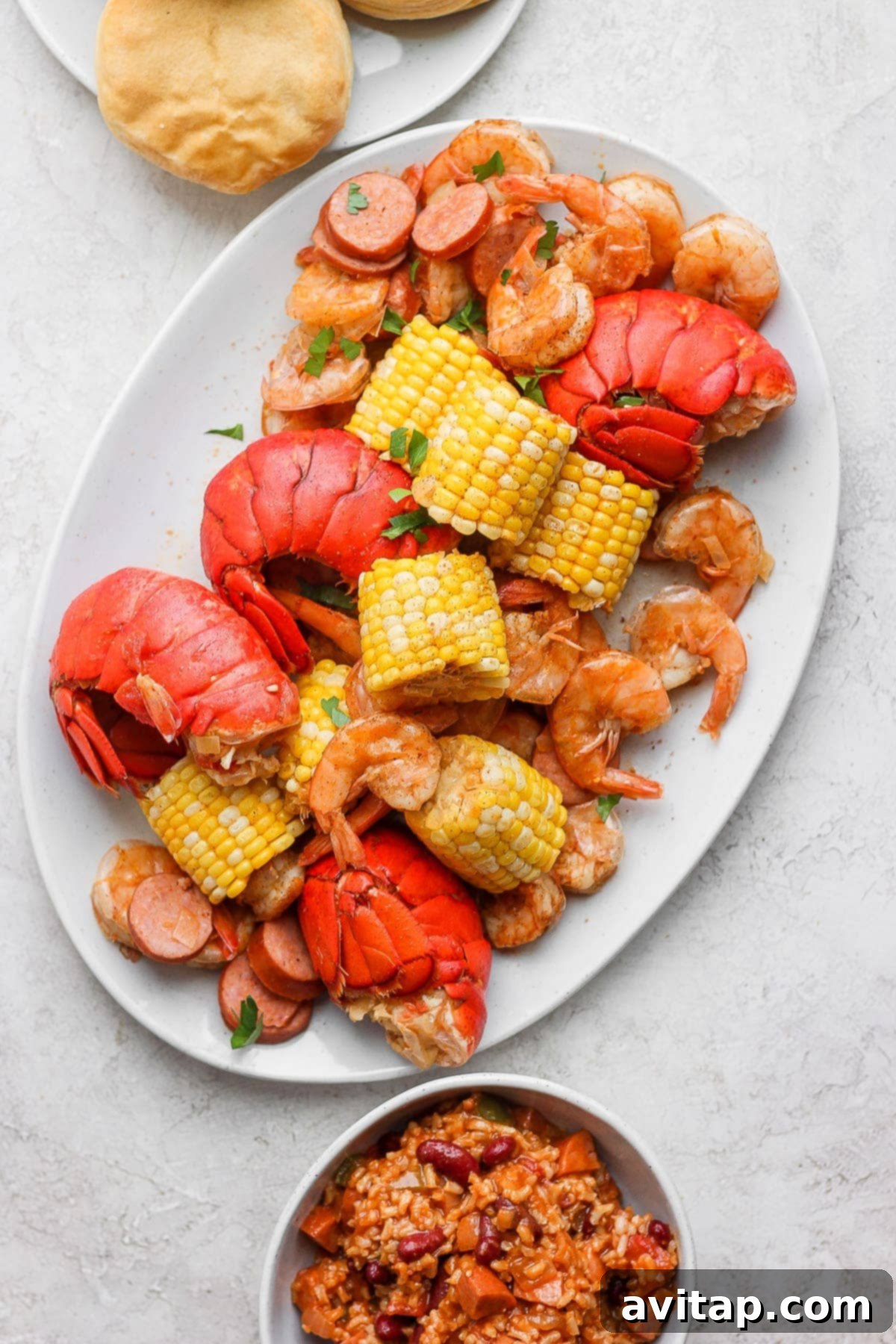 A beautifully plated easy seafood boil, showcasing lobster, shrimp, sausage, corn, and potatoes, ready to be enjoyed.