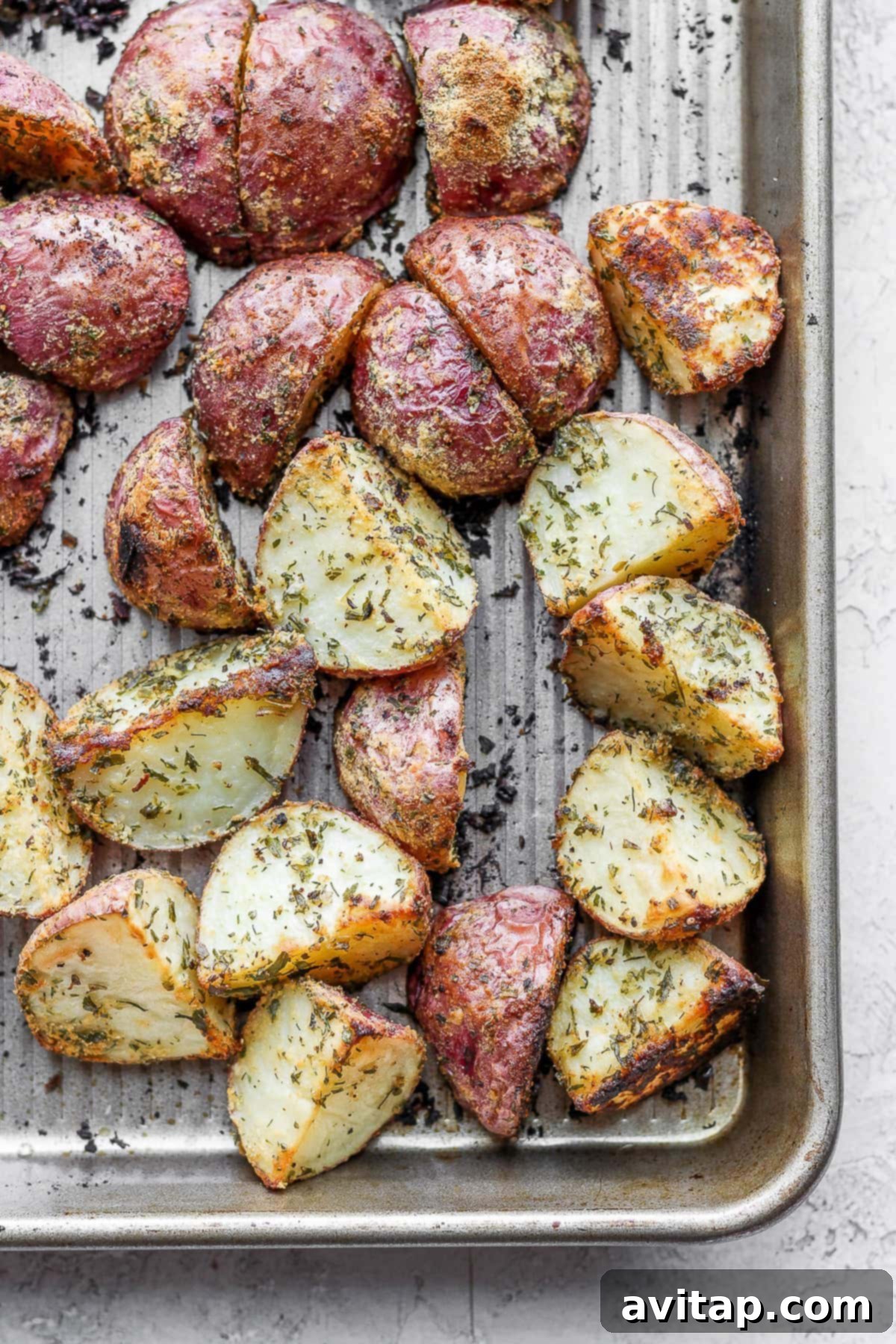 Perfectly roasted red potatoes, golden and crispy Roasted red potatoes on a baking sheet looking crispy and delicious